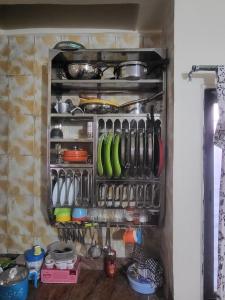 a kitchen drawer filled with lots of cooking utensils at Hari Prasad Homestay in Shirdi