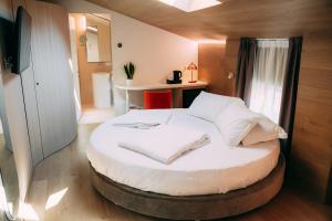 a large bed in a room with a table at Borgo di Lazise in Lazise