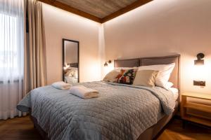 a bedroom with a bed with two towels on it at Olesiówka in Nowy Targ
