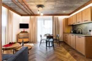 a kitchen and living room with a table and chairs at Olesiówka in Nowy Targ