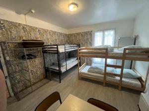 a room with three bunk beds and a table at Alpazur in Nice