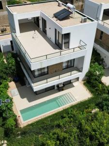 an aerial view of a house with a swimming pool at Bustani Villa in Mchamba Wima