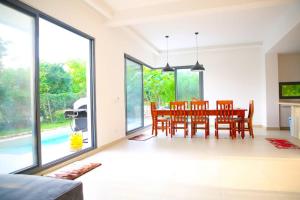 a dining room with a table and chairs at Bustani Villa in Mchamba Wima +3 photos