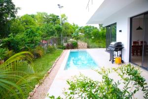 a swimming pool in the backyard of a house at Bustani Villa in Mchamba Wima