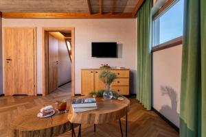 a living room with a table and a tv at Olesiówka in Nowy Targ