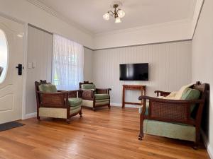 a living room with chairs and a flat screen tv at Casa Tranquilo in Kanighan