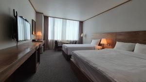 Postel nebo postele na pokoji v ubytování 퀸벨호텔 + 14 fotografií