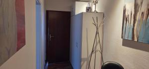 a room with a cabinet with a plant on the wall at Berg Messe 5, w-lan, Homeoffice in Bergisch Gladbach