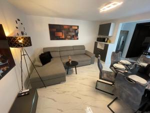 a living room with a couch and a table at Second home apartment - silver in Kustići