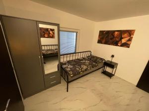 a bedroom with a bed and a mirror at Second home apartment - silver in Kustići
