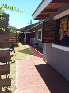 a patio of a house with a table and chairs at Forza e avanti in Santa Teresita
