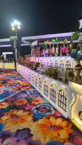 a large carpet with flowers on a dance floor at Hotel Shri Radha Nikunj - Opposite Prem Mandir in Vrindāvan