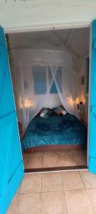 a bedroom with a bed in a tent at Bungalow Carambole - Bleu des Iles vue mer in Deshaies