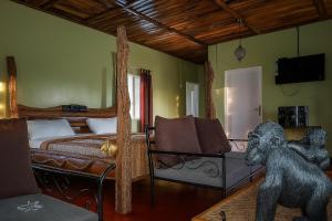 a bedroom with a bed and a statue of a monkey at Voyager's Center in Kikorongo