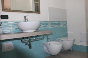 een badkamer met een wastafel en een toilet bij B&B MARIMA 2 POSTI ORGOSOLO in Orgosolo