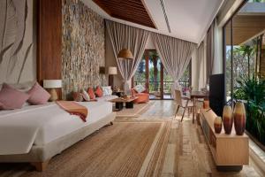 a bedroom with a bed and a living room at Samanea Wellness Resort in Phumĭ Tŭk Lŭy +59 photos