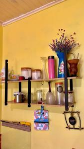 a wall with shelves filled with pots and pans at Casa Refúgio Cataratas by Grasi in Foz do Iguaçu