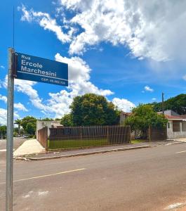 a blue street sign on the side of a road at Casa Refúgio Cataratas by Grasi in Foz do Iguaçu +59 photos