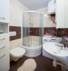 a bathroom with a shower and a toilet and a sink at Apartment Mirjana in Split