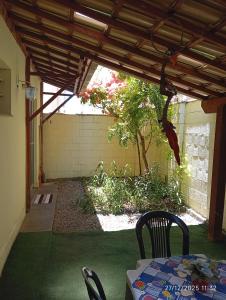 a patio with a table and chairs under a pergola at Apto térreo com área privativa ! in Rio das Ostras