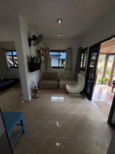 a living room with a couch and a tv at SU house Koh Phangan in Thong Nai Pan Yai +98 photos