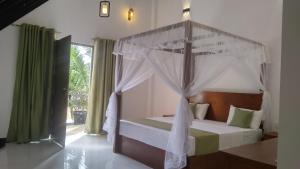 a bedroom with a bed with a canopy at Green Luxe in Dambulla +94 photos