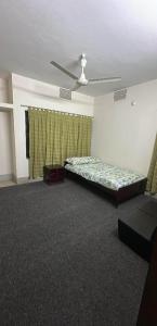 a bedroom with a bed and a ceiling fan at Lake Circus Heritage in Dhaka