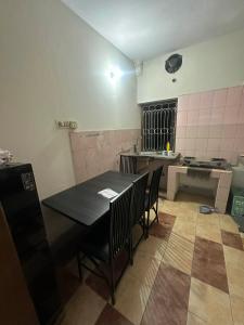 a kitchen with a table and chairs in a room at Lake Circus Heritage in Dhaka