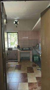 a large kitchen with a tile floor and a window at Lake Circus Heritage in Dhaka