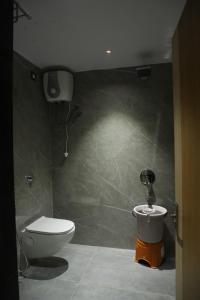 a bathroom with a toilet and a bidet at Hotel N Grand in Miriālgūda