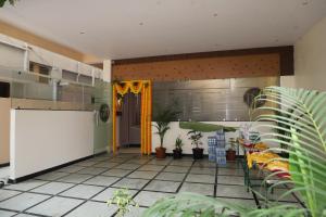 a kitchen with plants in a room at Hotel N Grand in Miriālgūda
