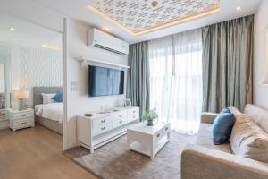 a living room with a couch and a tv and a bed at Seavale patong phuket in Patong Beach +57 photos