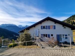 a house in the mountains with mountains in the background at Chalet Emely in Bartholomäberg
