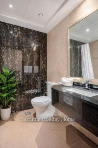 a bathroom with a toilet and a sink and a mirror at Studio for 4 just 5 Min Walk to Burj Khalifa, Downtown Dubai, Tower Elite 1 in Dubai