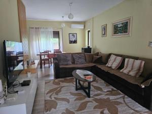 a living room with a couch and a table at Kristina Guesthouse in Librazhd