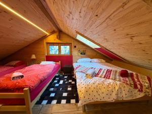 a bedroom with two beds in a attic at Charmant chalet authentique de montagne Bleusy- Nendaz idéal couple et famille in Saclentse
