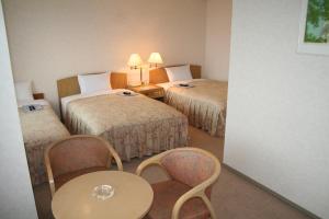 Postel nebo postele na pokoji v ubytování Urban Hotel Sanko