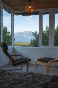 a porch with a chair and a bench and a window at Gurba's House in Aridaia