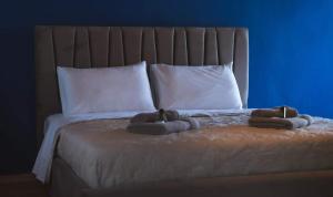 a bed with two towels on top of it at Gurba's House in Aridaia +3 photos