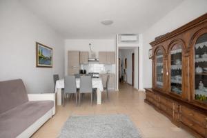 a living room with a table and a dining room at Dimoras 3BR City Center Terrace & Parking in Olbia
