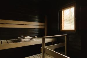 a bed in a room with a window and a window at Matilda Villas, quality villas by the sea in the beautiful village of Mathildedal in Matildedal