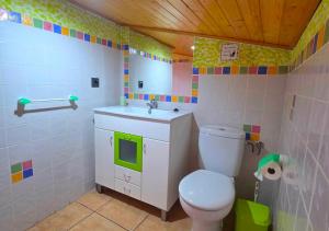 a bathroom with a toilet and a sink at Areatza Home Mountain in Santiago de la Espada +42 photos