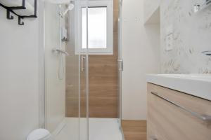 a glass shower in a bathroom with a sink at San Ambrosio in Granada +9 photos