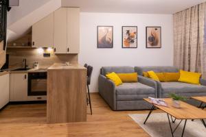 a living room with a couch and a table at Royal Crown Apartments in Subotica