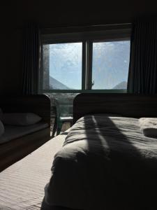 a bedroom with a bed and a large window at Gauthali Inn in Netadurling