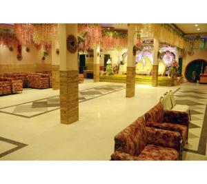 a large lobby with couches and christmas decorations at The Kuber Hotel in Bareilly +9 photos