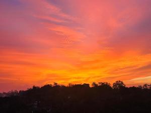 a colorful sunset with trees in the foreground at Villa Calton 32 Villa in Weligama Bay in Weligama