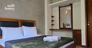 a bed in a hotel room with a mirror at nelli house in Galle +48 photos