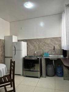 a kitchen with a refrigerator and a stove and a sink at Casas do Matteo - 2ª Praia in Morro de São Paulo +53 photos