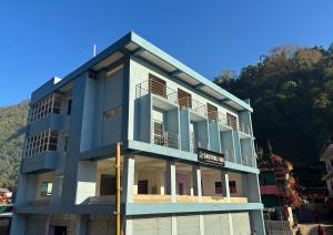 a blue building with balconies on the side of it at Gauthali Inn in Netadurling